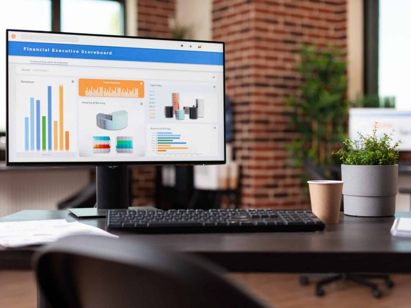 Computer with financial company data on charts in office. Empty business space with economy analytics following rate trend on monitor to make investment for organization development.